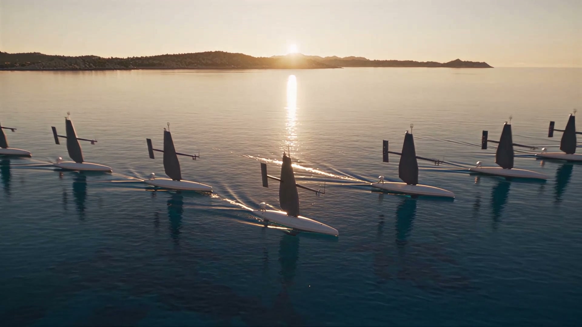 Three sail drones in formation near the coast