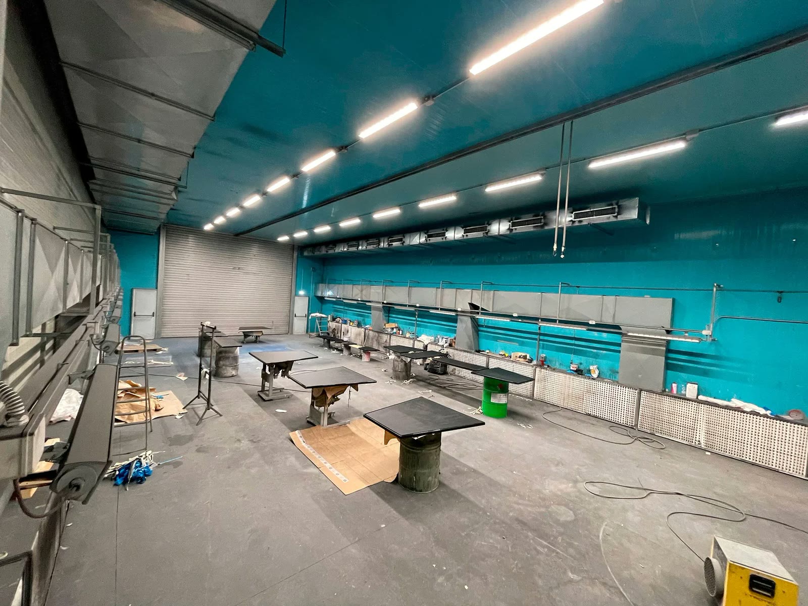 The workshop in Macchiareddu: benches, tooling and the blue walls of the hangar