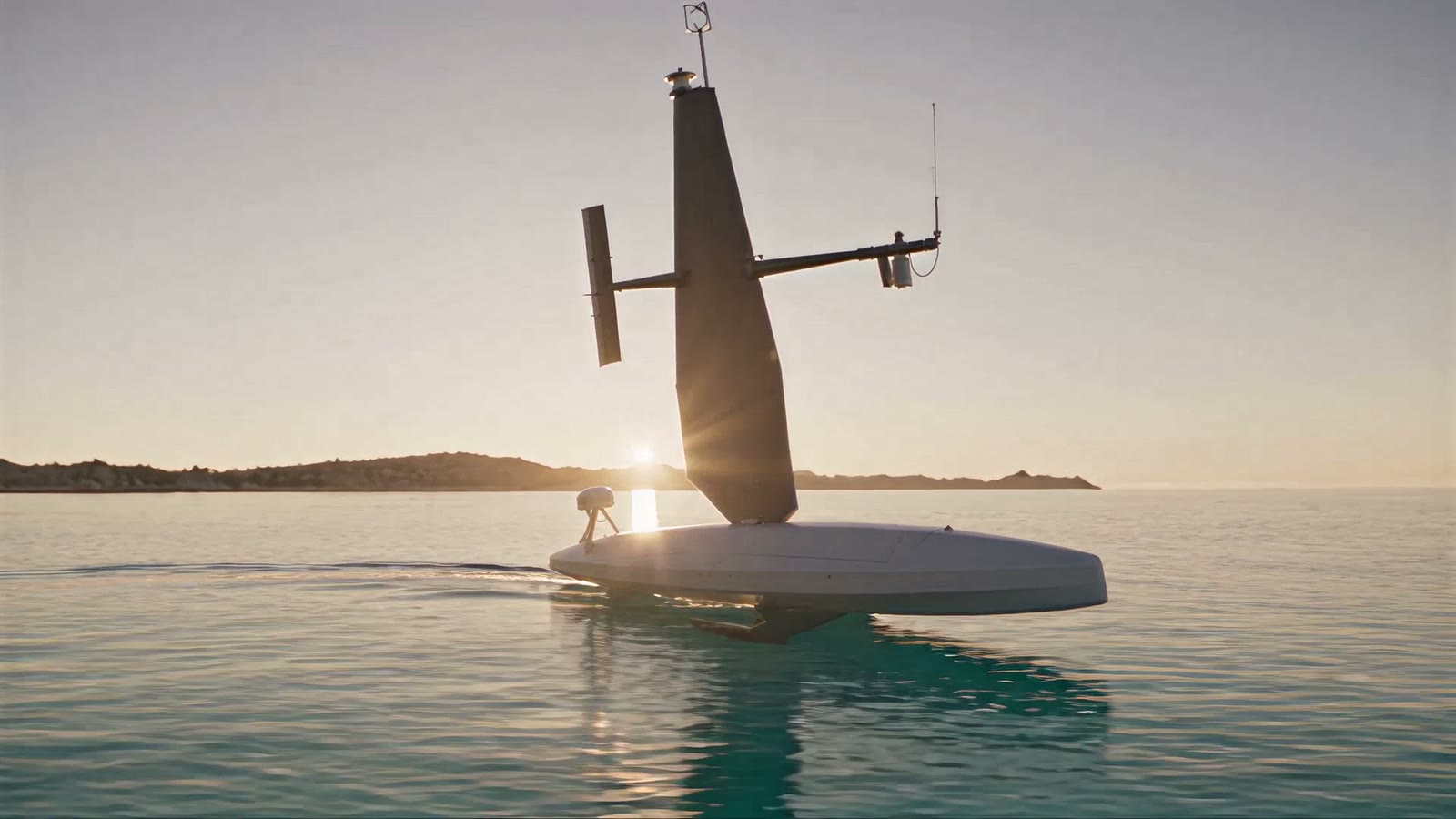 The Maistrale sail drone in profile against the low sun, wing sail up