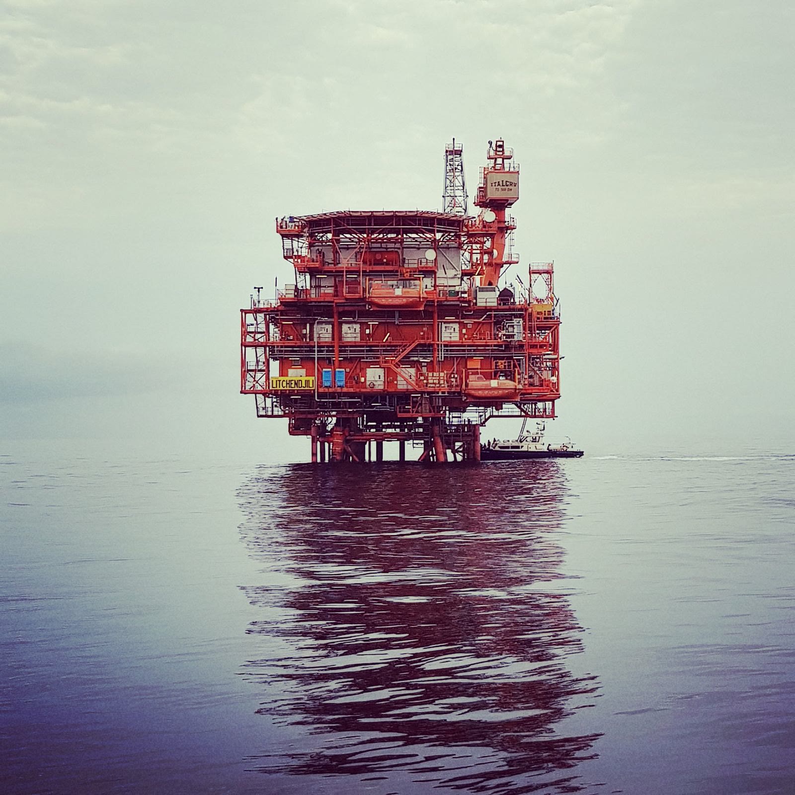 An offshore platform reflected on a calm sea