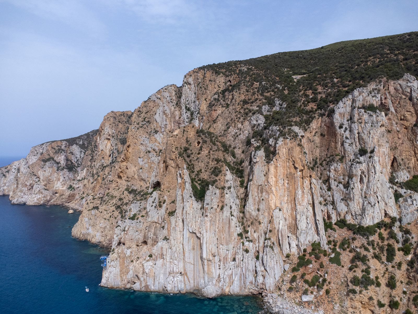 The limestone cliffs of the Sardinian coast over clear water